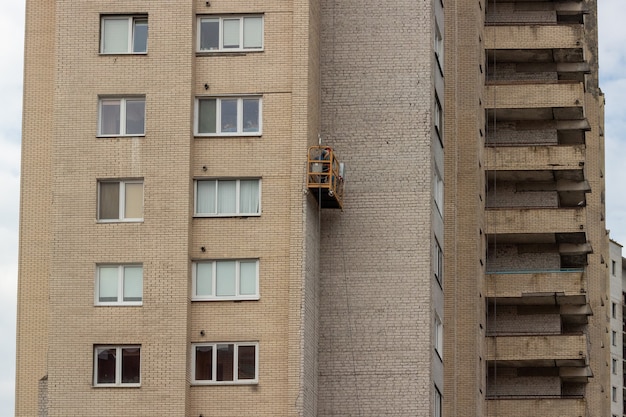 Réparation d'un immeuble Enlèvement des tuiles de la façade de la maison