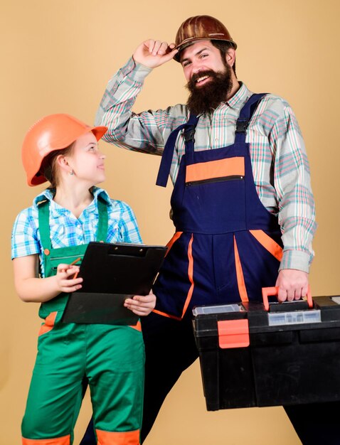 Réparer la créativité des enfants Homme barbu avec une petite fille assistant ouvrier du bâtiment Constructeur ou charpentier Uniforme de réparateur Ingénieur Père et fille dans l'atelier Rendre les choses belles