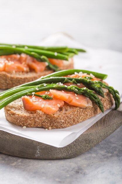 Repas végétarien sain. Toast, asperges, saumon. Table en pierre. Régime alimentaire propre. Alimentation biologique.