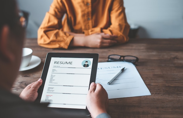 Les responsables des ressources humaines interrogent des candidats qui remplissent leur curriculum vitae sur le formulaire de demande d'emploi afin d'envisager d'accepter un emploi en tant qu'entreprise.