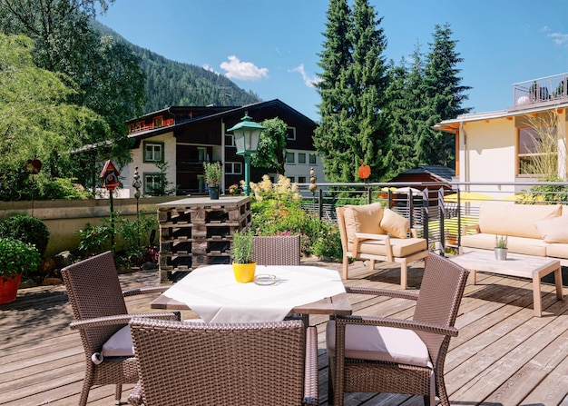 Restaurant de rue avec tables et chaises à l'hôtel resort de Bad Kleinkirchheim en Carinthie, Autriche. Conception d'un café-terrasse. Mode de vie et nature. Terrasse ou véranda de café prête pour le petit déjeuner