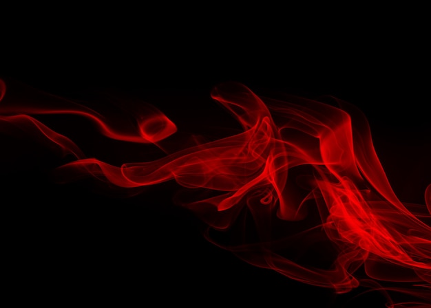 Résumé de fumée rouge sur fond noir. conception du feu