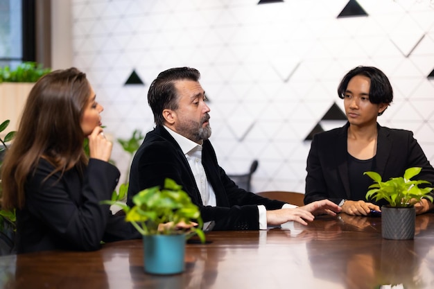 Réunion d'affaires Groupe de diversité hommes et femmes assis dans une salle de conférence et souriants lors de la réunion Plan de recherche dans la salle de conseil Des hommes d'affaires professionnels brainstorming et concept de travail en équipe