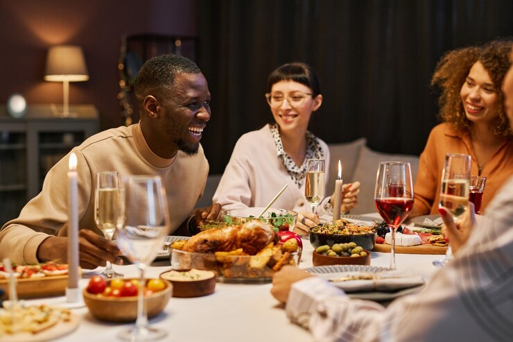 Photo rire homme noir avec flûte de champagne penché sur la table servie