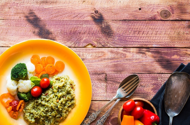 Photo risotto aux légumes, sur fond de bois