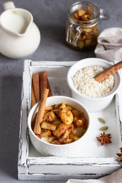 Riz au lait avec des fruits, du miel et des épices. Petit déjeuner ou dessert sain.