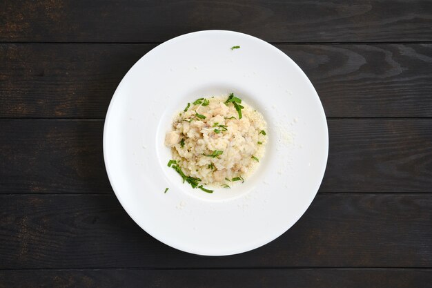 Riz aux morceaux de poulet et fromage râpé sur table en bois foncé