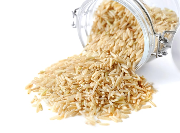 Riz brun à grain long et bocal en verre sur fond blanc