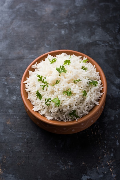 riz à la coriandre ou à la coriandre, servi dans un bol en céramique ou en terre cuite. C'est une recette indienne ou chinoise populaire. Mise au point sélective