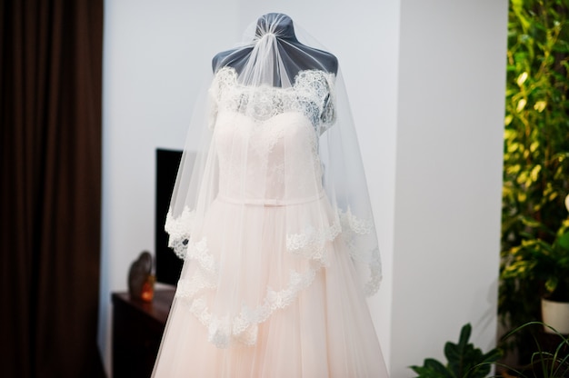 Robe de mariée au milieu de la pièce isolée.