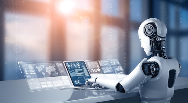 Le robot humanoïde XAI utilise un ordinateur portable et s'assoit à la table pour l'analyse de grandes données