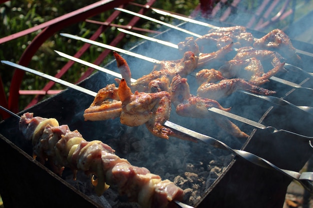 Rôtir le shish kebab juteux sur le gril dans la nature