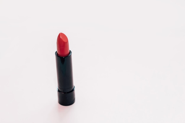 Rouge à lèvres des femmes cosmétiques rouges sur fond blanc