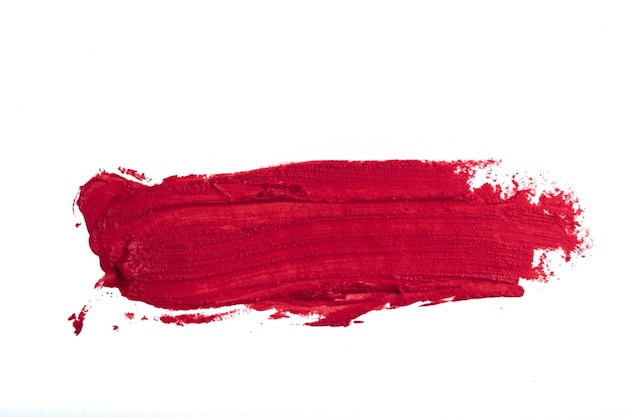 Le rouge à lèvres taché isolé sur fond blanc