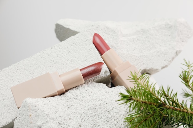 rouges à lèvres brillants sur fond de pierres naturelles cosmétiques vente de noël ou vacances d'hiver offre spéciale mise au point sélective concept de maquillage de vacances décor de style minimal