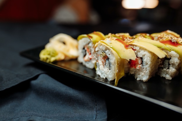 Rouleau de sushi Golden Dragon avec thon, concombre, graines de sésame et caviar tobiko.