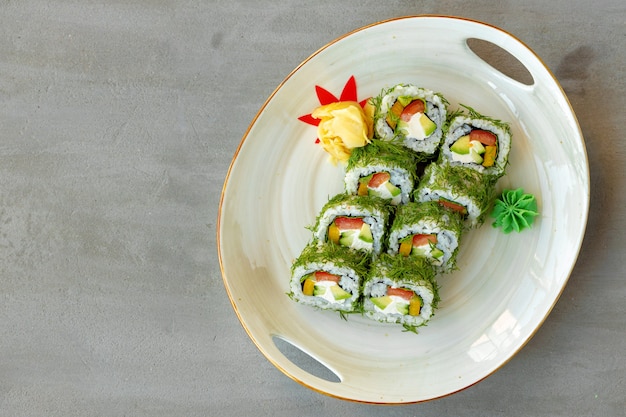 Rouleau de sushi végétarien à l'aneth et légumes sur fond de bois