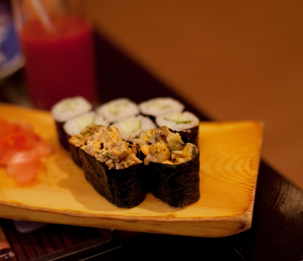 Rouleaux de maki servis sur plaque de bois