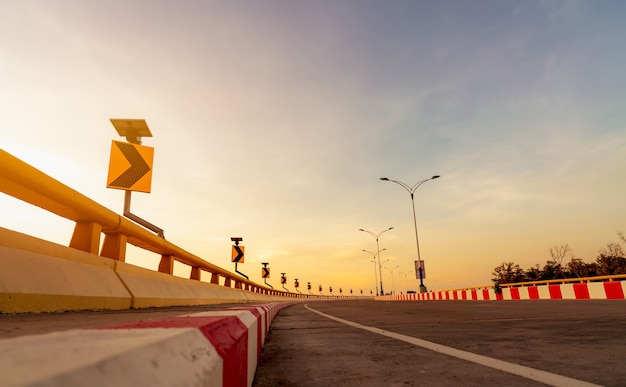 Route en béton courbe avec panneau de signalisation courbe et panneau d'arrêt interdit rouge-blanc