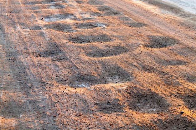 La route en hiver, la chaussée est recouverte de neige fondue après le nettoyage et un grand nombre de voitures qui la traversent