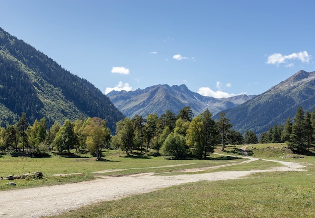 Photo route de montagne dans un panorama d'une vallée de montagne ensoleillée