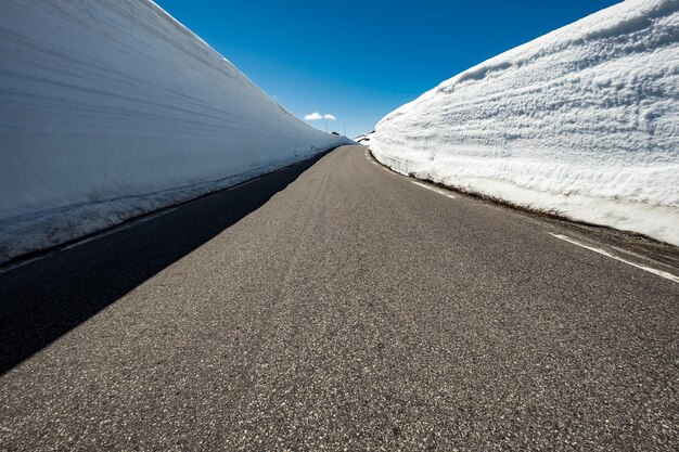 Route de montagne en Norvège avec un haut mur de neige