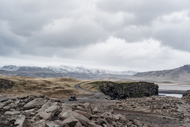 La route qui mène à l'horizon, les montagnes rocheuses enneigées. Près de Black Beach Vik, Islande
