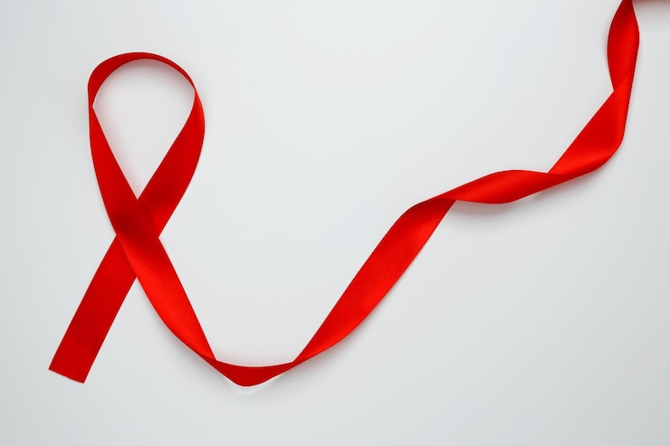 Photo un ruban rouge avec une sensibilisation au sida sur un fond blanc journée mondiale du sida