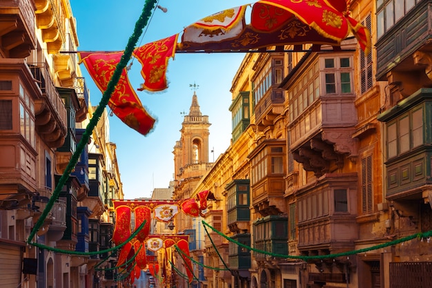 Rue décorée de façon festive avec des bannières pour la fête de Saint Augustin dans la vieille ville de La Valette, Malte