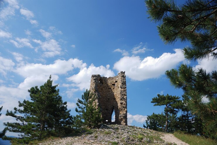 Photo ruine einer alten burg auf einem berg mit blauen himmel