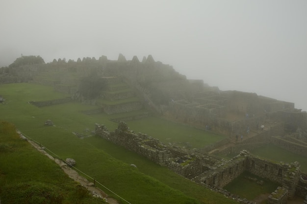 Ruines de l'ancienne cité Inca Machu Picchu dans le brouillard Pérou