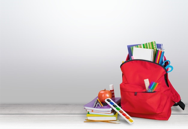 Sac à dos scolaire rouge sur fond.