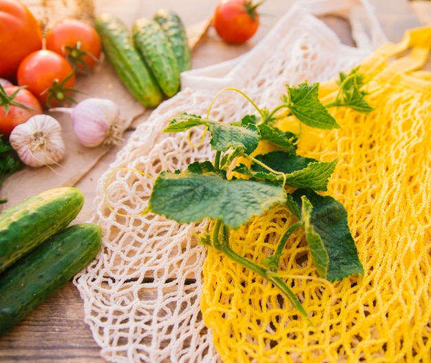 Sac à provisions réutilisable sac à cordes fait de matériaux recyclés sur une table en bois parmi les légumes frais Pas de plastique Mode de vie écologique