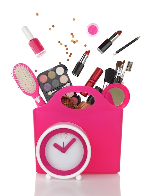 Sac à provisions rose et horloge avec divers produits cosmétiques isolés