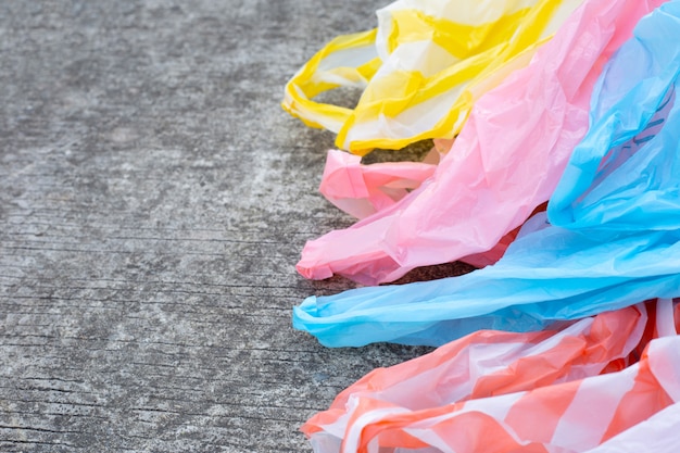 Sacs à ordures en plastique sur sol en ciment.