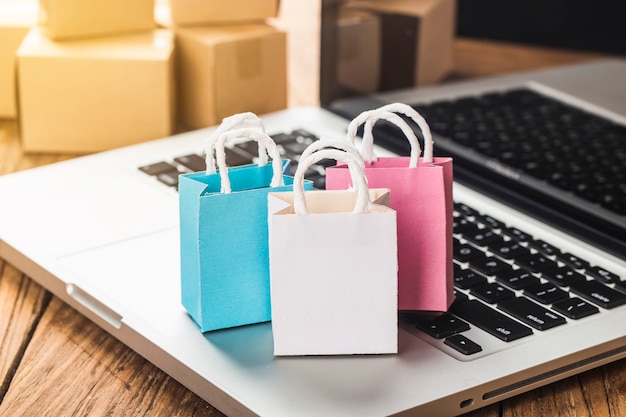 Sacs en papier colorés dans un chariot Idées sur la dépendance au shopping en ligne