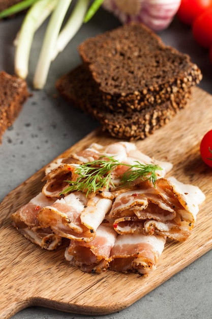 saindoux ukrainien saindoux de porc saupoudré d'herbes fraîches hachées sur une planche de bois