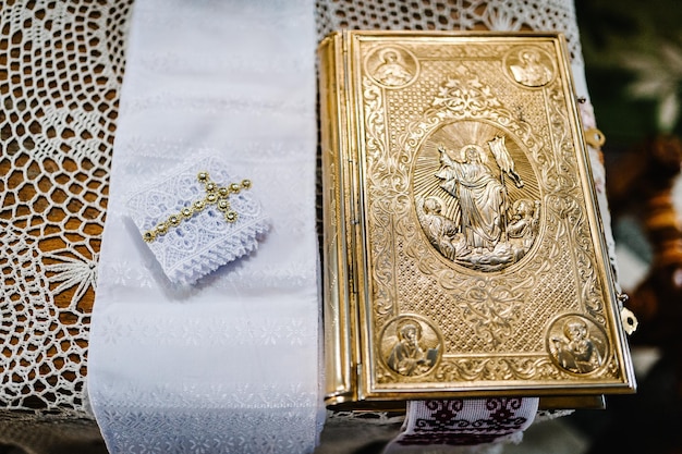 Sainte Bible décorée d'or et d'icônes Couronnes de mariage debout sur la table à l'église Close up Divine Liturgy