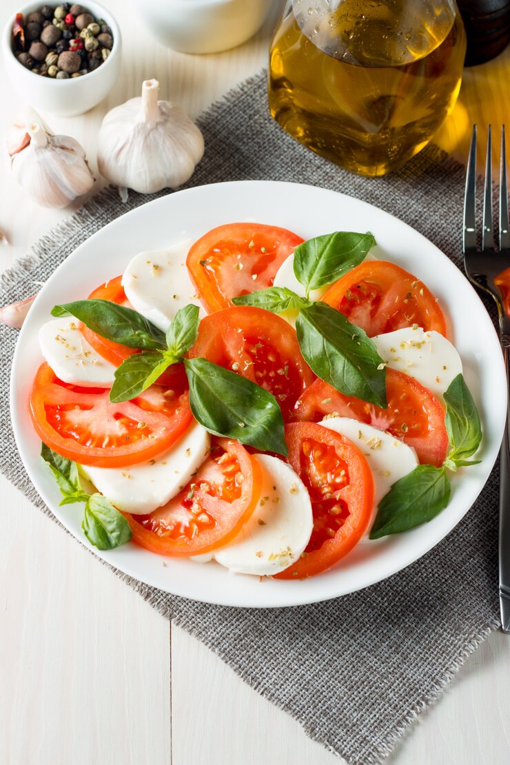 Photo salade caprese avec tomates, basilic, fromage mozzarella.