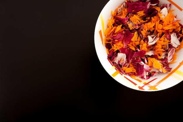 Salade de carottes sur tableau noir, vue de dessus. Fond de nourriture