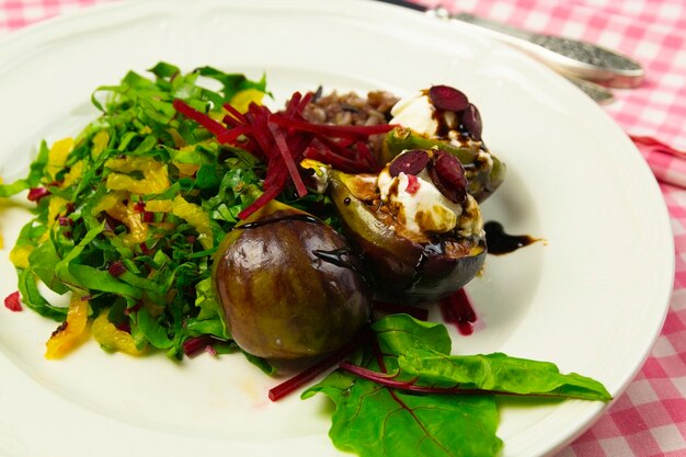 Salade de figues au fromage de chèvre et betteraves, sur une plaque blanche sur une nappe à carreaux