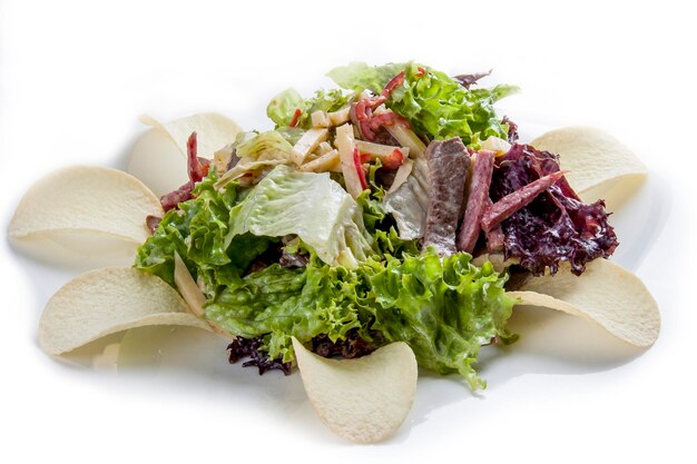 Salade avec langue et légumes verts avec frites sur fond blanc