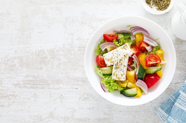 Salade de légumes d'été frais avec laitue tomate concombre poivron oignon et fromage feta habillé d'huile d'olive Vue de dessus