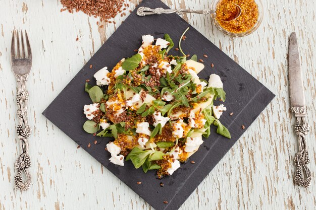 Salade de pommes, fromage et fines herbes, assaisonnée de sauce à la moutarde.