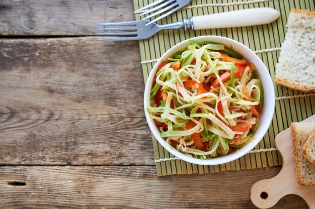 Salade de radis vert et poivron dans un bol blanc