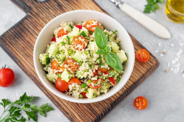 Salade de taboulé Salade de couscous aux légumes frais et aux herbes dans un bol Copy space