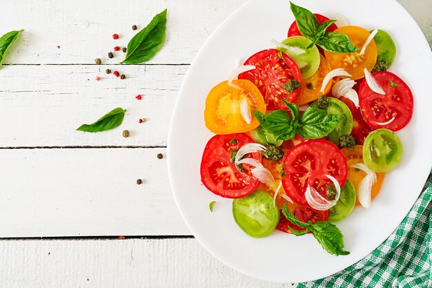 Photo salade de tomates colorées au pesto d'oignons et basilic.