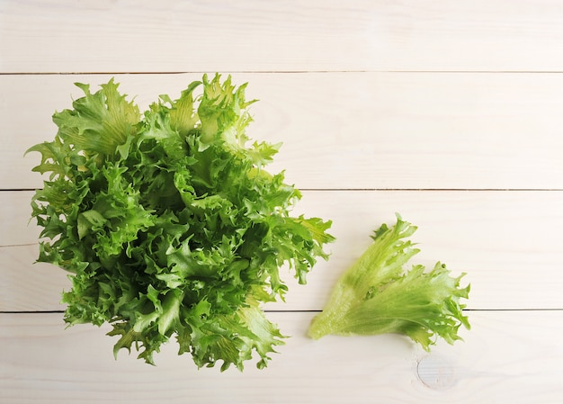 Salade verte feuilles sur fond en bois