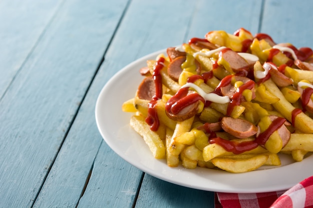 Salchipapa d'Amérique latine typique. Saucisses avec frites, ketchup, mayo et moutarde. Espace copie