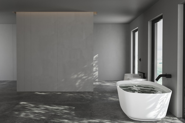 Une salle de bain moderne avec baignoire blanche aux murs gris et adaptée pour mettre en valeur les armoires de salle de bain avec sol en béton Parfait pour les maquettes Rendu 3D